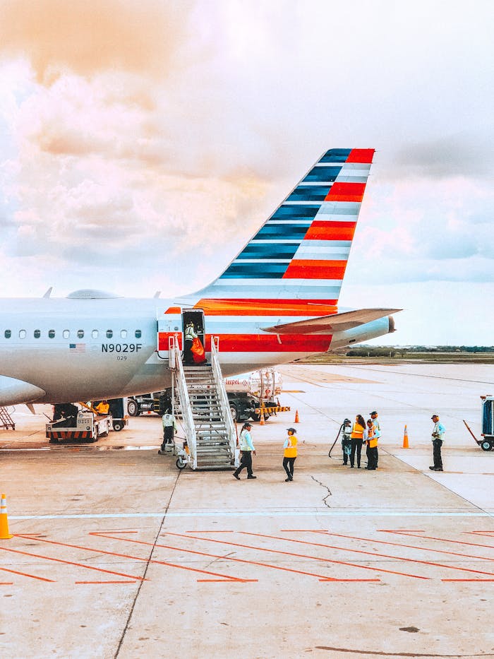 A colorful airliner being prepared for boarding on a sunny day at an airport.